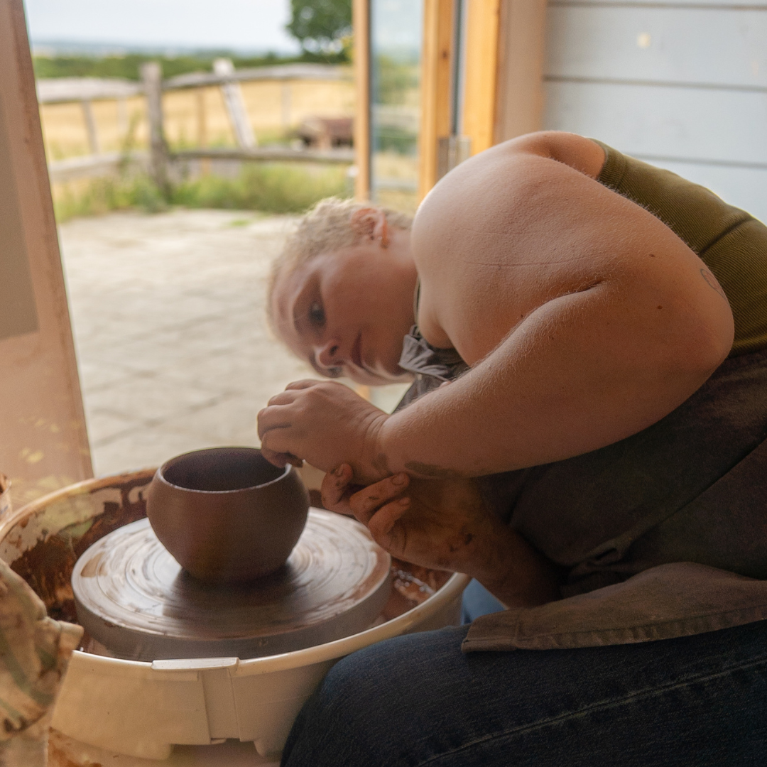 Lauren, ceramic artist from Mudfired, on her potting wheel.